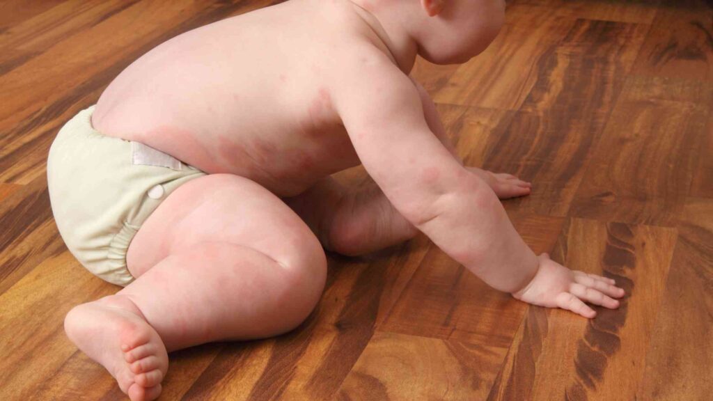parent observing a baby after introducing allergenic foods