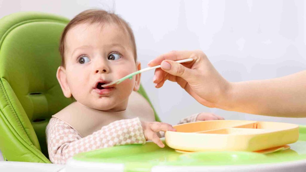 parent introducing allergen foods to a baby during first solids